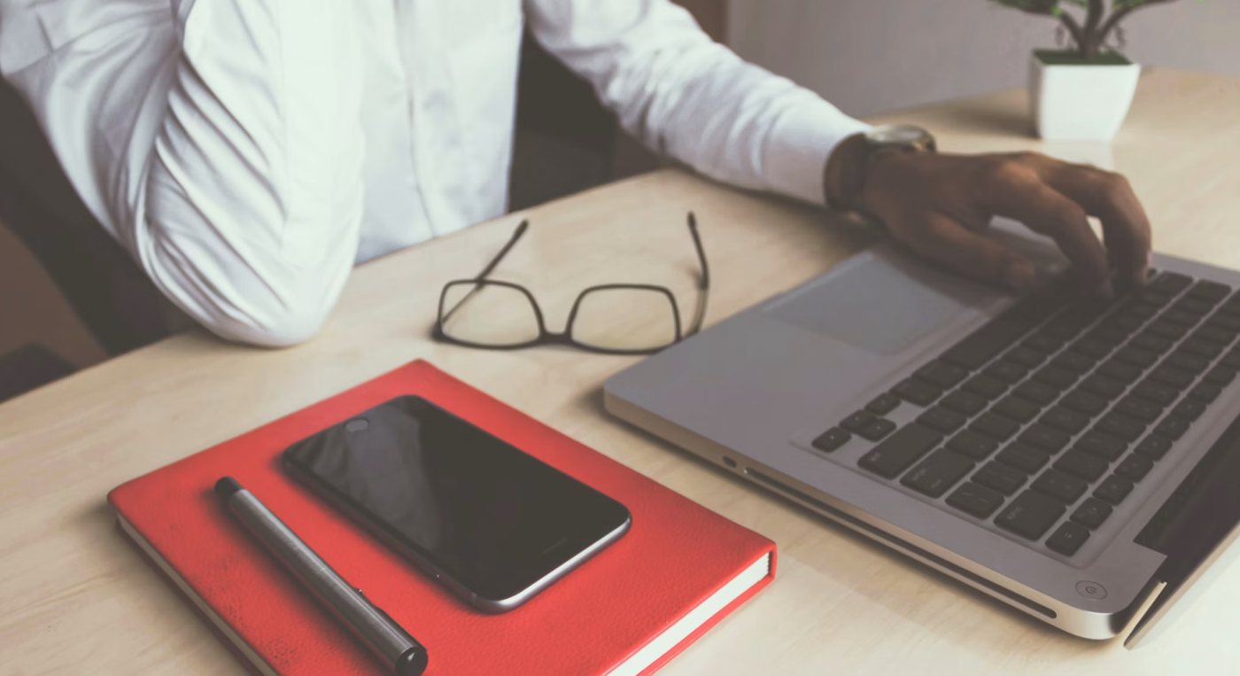 Black male office worker focused on work while sitting at his desk